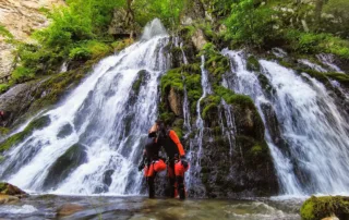 man canyoning waterfall sutjeska national park