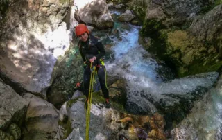 canyoning girl with rope and guide